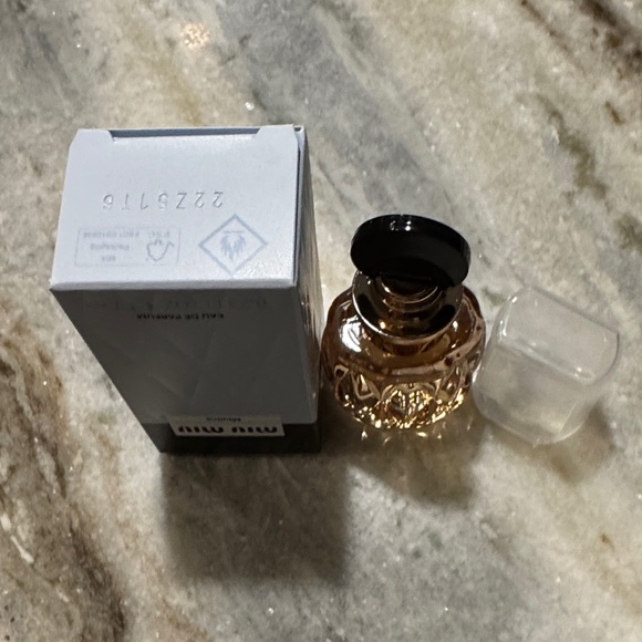 Miu Miu Eau de Parfum with Black top and clear Cap and Gold Accents dab on - Picture 3 of 3